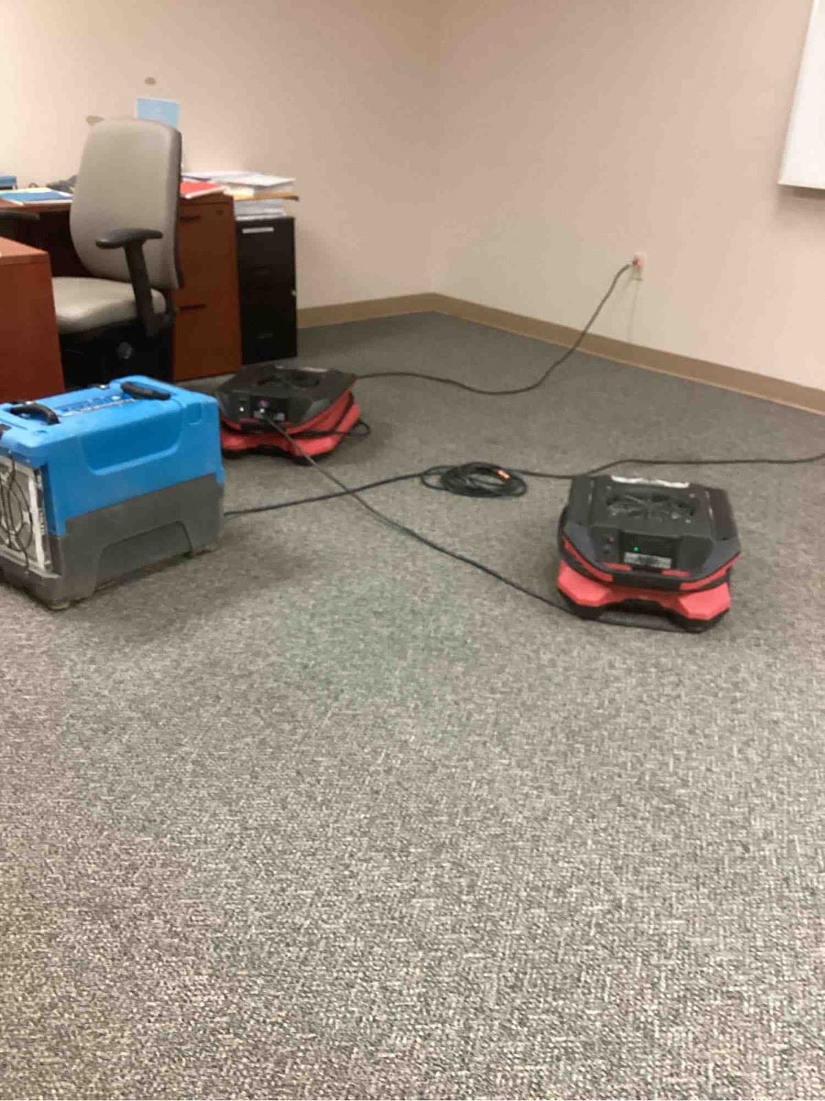 High-velocity air movers positioned across an office floor during structural drying in Louisville
