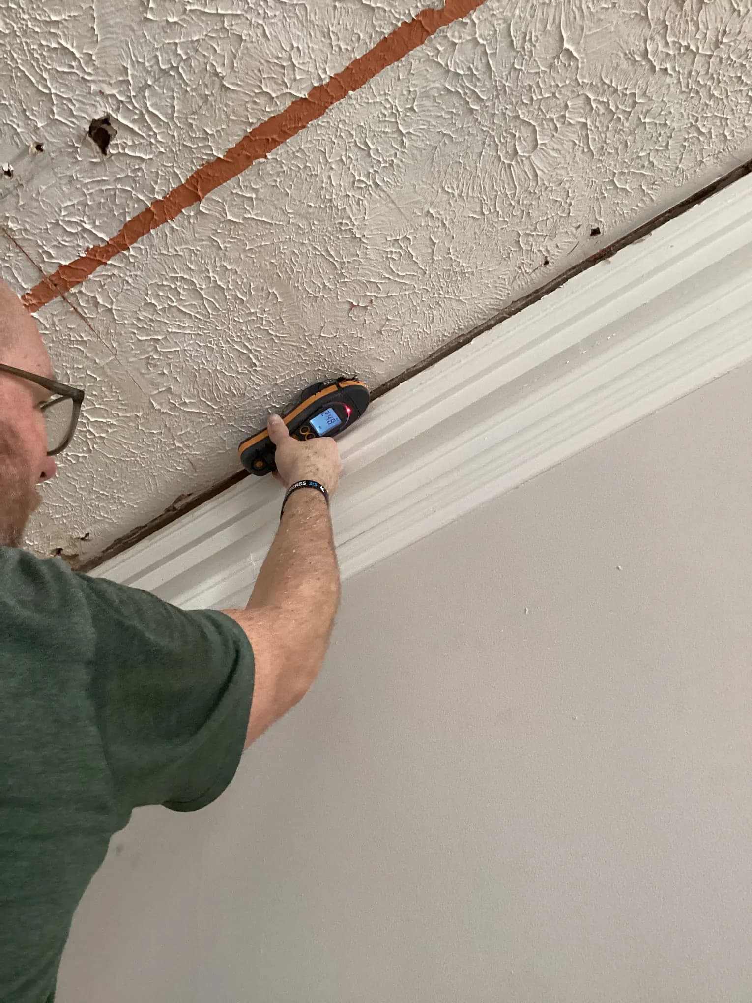 Moisture meter used on a ceiling during a mold inspection in a Louisville home