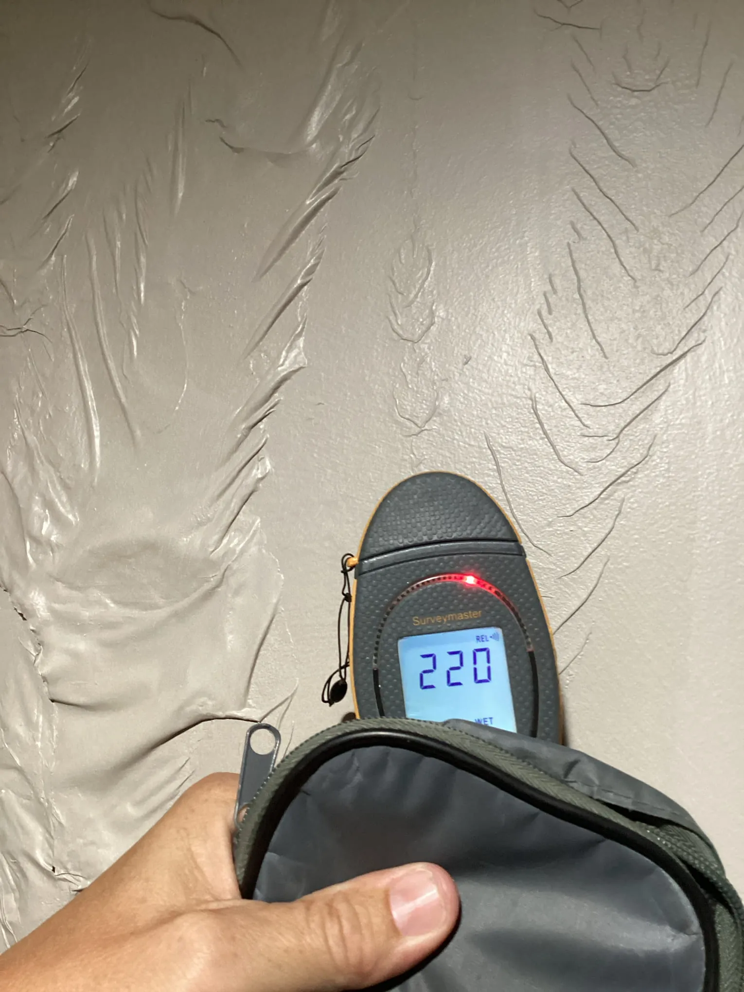 Protimeter moisture reading taken on a wall to verify drying progress in a Louisville property
